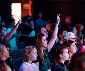  Joyful congregation worshiping, showing unity and shared purpose in Christ.