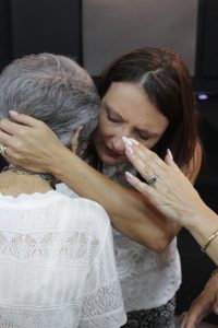 Elderly lady being prayed over during the anointing service.